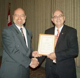 Tim Henderson presenting the Fellow of the C.N.A. Award to Dan Gosling